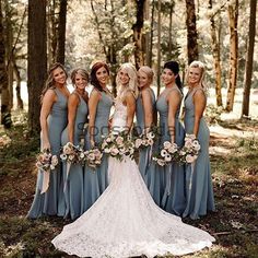 a group of women standing next to each other in the woods