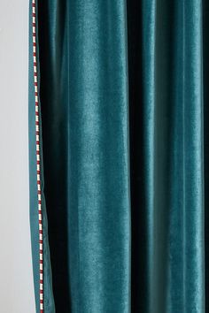 green curtains with red and white trim on them