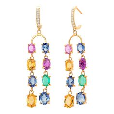 This is part of Chairish’s Fine Jewelry assortment.  Introducing our exquisite 14 Karat Yellow Gold Double Lined Multi-Colorful Precious Stones Dangling Drop Hoop Earrings, a true testament to elegance and style. Crafted with meticulous attention to detail, these earrings are designed to captivate and mesmerize. Each earring features a stunning array of precious stones, carefully selected to create a vibrant and fashionable presentation. Sparkling diamonds, weighing a total of 0.25 carats, add a Elegant Multicolor Dangle Hoop Earrings, Elegant Multicolor Gemstone Hoop Earrings, Elegant Multicolor Oval Earrings, Drop Hoop Earrings, Yellow Sapphire, Sparkle Diamonds, Gold Hoop, Gold Hoop Earrings, Chandelier Earrings