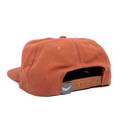 a brown hat with a leather patch on the front