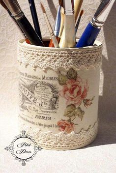 a cup with some pens and pencils in it