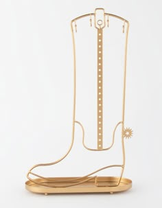 a pair of gold cowboy boots on a white background