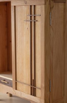 a wooden cabinet with metal handles and drawers