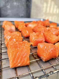 several pieces of raw salmon on a rack in the oven, ready to be cooked