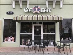 the outside of a cafe with tables and chairs