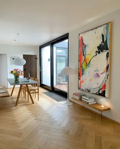 a living room filled with furniture and a painting on the wall