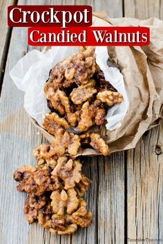 crock pot candied walnuts on a wooden table with the title above it