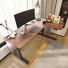 a computer desk with a monitor, keyboard and mouse on it in front of a window