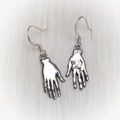 Palmistry Fortune Teller earrings. Pewter hand charms on your choice of silver plated or gold plated brass ear hooks: * Fish hook * Lever back * Kidney (47mm, will fit through stretched ear tunnels) * Post-style * Clip on (non-piercing)  * Sterling Silver Fish hooks * 14K Gold-Filled Fish hooks NOTE: If you select the .925 sterling fish hooks, but 'gold' charms, the ear hooks will be silver not gold. (Alternatively if you select 14k GoldFilled hooks and 'silver' charms, the hooks will be gold) ..: V I E W  S H O P:.. www.lotusfairy.etsy.com www.shopEarthshine.com ..: P O L I C I E S :.. Please see the drop down FAQs menu All items are FINAL SALE. ★  I M P O R T A N T  ★ This product is not intended to be used by, or around,  anyone under the age of 13.  ShopEarthshine.com ★ lotusfairy.etsy Symbolic Dangle Jewelry With Ear Wire, Nickel-free Sterling Silver Dangle Clip-on Earrings, Nickel-free Sterling Silver Clip-on Earrings As Gift, Nickel-free Sterling Silver Clip-on Earrings, Novelty Dangle Jewelry For Jewelry Making, Nickel-free Novelty Drop Earrings, Handmade Silver Brass Clip-on Earrings, Silver Dangle Clip-on Earrings In Brass, Nickel Free Novelty Sterling Silver Earrings