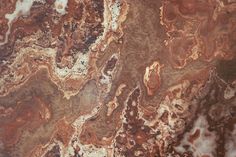 an image of marble that looks like it has brown and white streaks on the surface