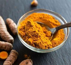 tumerical and ginger powder in a glass bowl with spoon