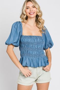 Denim smocked peplum look top. Features: regular size, standard, young contemporary, contemporary, peplum look, denim, smocked detail, top, blouse, short sleeves, puff sleeves, square neck, low back, cute, trendy, stylish, fashionable, daily wear, everyday wear, spring, summer, ss, women's clothing, women's apparel, women's wear Fabric Content 100% Lyocell Care Instruction Hand Wash Cold, Do Not Bleach, Hang To Dry Summer Medium Wash Denim Top With Puff Sleeves, Medium Wash Puff Sleeve Denim Top For Summer, Medium Wash Denim Top With Puff Sleeves For Summer, Summer Smocked Top With Ruffle Hem And Short Sleeves, Trendy Spring Denim Top With Puff Sleeves, Trendy Puff Sleeve Denim Top For Spring, Short Sleeve Smocked Bodice Top For Brunch, Smocked Bodice Short Sleeve Top For Brunch, Summer Puff Sleeve Denim Top