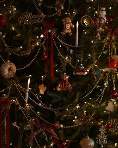 a decorated christmas tree with candles and ornaments