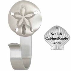 an image of a blue sand dollar on a metal hook with the sealife cabinet knobs com logo below it