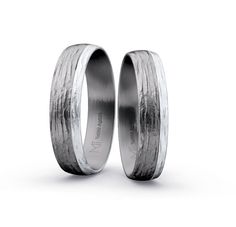 two wedding bands made out of silver and white gold, each with a textured finish