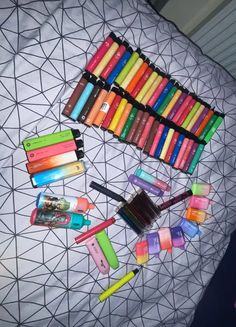 there are many different colored crayons on the bed