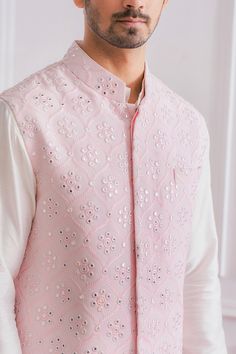 Powder pink Nehru jacket in pure georgette base fabric featuring machine and mirror embroidered motifs.
Component: 1
Pattern: Embroidered
Type Of Work: Mirror Work
Neckline: Mandarin
Sleeve Type: Sleeveless
Fabric: Pure Georgette; Lining: Twill Satin
Color: Pink
Other Details: 
Front button down jacket
Pocketed jacket
Note: The kurta and churidar worn by the model is not for sale
Occasion: Wedding - Aza Fashions Pink Nehru Jacket For Men, Pink Kurta For Men, Groom Haldi, Nehru Jacket With Kurta, Traditional Indian Mens Clothing, Nehru Jacket For Men, Boys Kurta Design, Wedding Kurta For Men, Indian Groom Wear