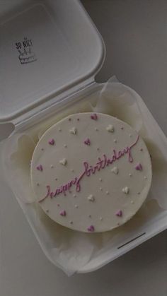 a birthday cake in a plastic container with the word happy birthday written on it