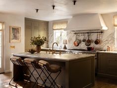 a kitchen with marble counter tops and an island