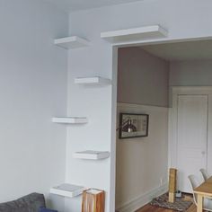 a living room filled with furniture and white walls