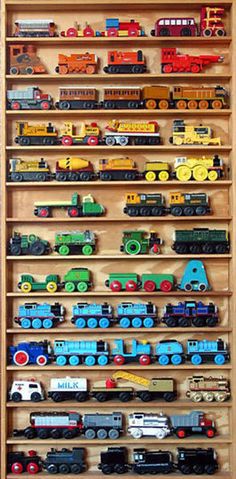 a wooden shelf filled with lots of toy trains