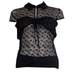 100% authentic Chanel cap sleeve top in black sheer star lace (nylon-spandex blend - please note the content tag is missing). Embellished with embroidered stars all over the top and a black satin band on the collar, sleeves and the hemline. Has an attached bandeau on top. Opens with a CC button on the front. Unlined. Has been worn and is in excellent condition. Measurements Tag Size Missing Size M Shoulder Width 74cm (28.9in) Bust 78cm (30.4in) to 90cm (35.1in) Waist 70cm (27.3in) to 90cm (35.1i Fitted Star Print Summer Tops, Fitted Star Print Tops For Summer, Black Stretch Top With Star Print, Black Short Sleeve Tops With Star Print, Fitted Star Print Top For Night Out, Fitted Star Print Tops For A Night Out, Fitted Sleeveless Top With Star Print, Black Lace Top With Short Sleeves, Sheer Lace Short Sleeve Top