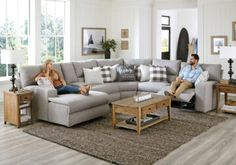 a man and woman sitting on a couch in a living room