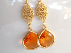 Stunning Gold long earrings featuring a beautiful orange color! These beautiful glass faceted beads are suspended from a gold connector and gold plated ear wire. Absolutely gorgeous and elegant!Earrings***Single glass bead : 16mm***Gold plated connector: 10mmx17mm***Earrings measure approximately 49mm including the ear wire***UPGRADE TO GOLD FILLED EAR WIRE FOR AN ADDITIONAL FEE*****Each pair of earrings will be individually wrapped, ready for gift giving!IF YOU HAVE ANY QUESTIONS, PLEASE CONVO Orange Drop Earrings For Anniversary, Orange Gemstone Jewelry For Wedding, Elegant Orange Earrings For Gift, Orange Pierced Earrings For Wedding, Orange Teardrop Jewelry For Wedding, Orange Dangle Earrings For Formal Occasions, Handmade Orange Earrings For Formal Occasions, Orange Drop Earrings For Wedding, Elegant Orange Earrings For Anniversary