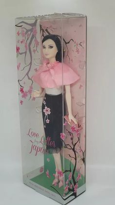 a doll in a box with pink flowers on it