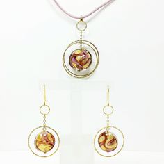 Offered for sale are these wonderful Murano Glass Gold Pendant Earrings Set! This gorgeous set is pre-owned. As with all our pre-owned jewelry, we have tested, cleaned and serviced this item to bring out the sparkle and shine! Particulars: Size & Measurements:   Earrings: Approx. 2" tall x 1" wide. Weight: 7.9 grams.  Pendant: Approx. 2 1/4 tall x 1.6" wide.  Necklace: 17" Weight total: 12.9 grams. Metal & Hallmark: Solid 14k Yellow Gold.   Hallmark: Near Clasp, 14KT Italy ALAD Gold Plated Pink Gold Round Jewelry, Pink Gold Plated Round Jewelry, Gold Dangle Jewelry With High Luster, Gold High-luster Dangle Jewelry, Gold Pendant Earrings With Elegant Design, Gold Round Pendant Earrings For Anniversary, Handmade Yellow Gold Jewelry For Formal Occasions, Gold Sterling Silver Jewelry Sets For Celebration, Formal Yellow Gold Jewelry Sets