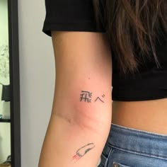 a woman's arm with chinese writing on the left side of her right arm