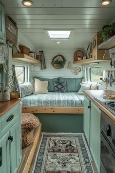 the interior of a tiny home with lots of storage space and green cupboards,