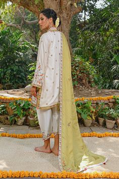 This intricately embroidered self jamawar kurta is a season favourite. The brightly embroidered florals offset the cream base. The shawl is beautifully worked with a mix of florals with a linear pattern. The look is completed with a rawsilk izaar that is finished with worked borders. Eid Embroidered Slub Silk Sherwani, Embroidered Slub Silk Sherwani For Eid, Traditional Embroidered Slub Silk Sherwani, Embroidered Slub Silk Sherwani With Traditional Drape, Traditional Tussar Silk Sherwani With Resham Embroidery, Traditional Chanderi Sherwani With Naqshi, Raw Silk Kurta With Floral Embroidery In Traditional Drape, Wedding Sherwani In Embroidered Slub Silk, Festive Unstitched Slub Silk Suit With Floral Embroidery