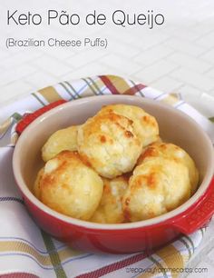 a red bowl filled with cheese puffs on top of a checkered table cloth