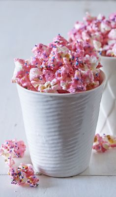 pink and white sprinkles are in a bowl