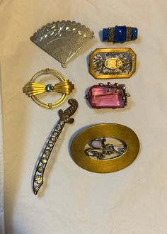 Nice lot of antique pins. There are 7 pins in the lot. They are all wearable. Pink stone has chip on edge. Overall good condition. Collectible Antique Brooch Lapel Pin, Antique Collectible Brooch Lapel Pin, Antique Collectible Lapel Pin Brooch, Vintage Handmade Collectible Pins, Handmade Art Deco Collectible Brooches, Handmade Art Deco Collectible Brooch, Antique Pins, Art Deco Brooch, Rose A