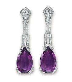 A PAIR OF ART DECO AMETHYST AND DIAMOND EAR PENDANTS   Each suspending a pear-shaped amethyst, with baguette-cut diamond prongs, from an openwork baguette and circular-cut diamond geometric link, to the pavé-set diamond plaque surmount, mounted in platinum, circa 1930 Bijoux Art Deco, Bijoux Art Nouveau, All Things Purple, Deco Jewelry, Elizabeth Taylor, I Love Jewelry, Diy Schmuck