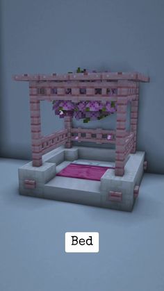 a bed made out of blocks with flowers on top and the word bed below it