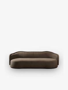 a brown couch sitting on top of a white wall