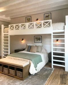 a bedroom with a bunk bed and white ladders on the wall, along with two storage baskets