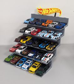 there are many toy cars on the shelves