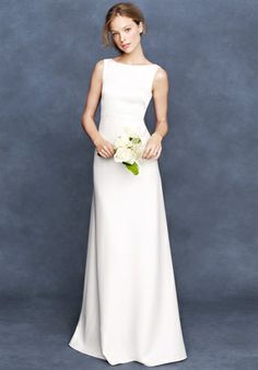 a woman in a white dress standing next to a gray background with the words, home wedding / bride percy gown