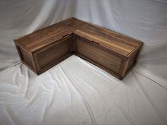 a wooden box sitting on top of a white sheet