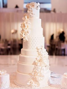 a white wedding cake with flowers on top