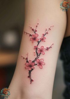 a woman's arm with pink flowers on the left side of her body,