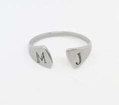 "This line of stainless steel rings is engraved with your choice of initials - either for a couple or your own. The ring is laser engraved permanently in black on the surface of the ring. This style stainless steel ring is adjustable and stackable. While the ring is adjustable, stainless steel can be harder to move so if you'd like me to adjust it for you (because I have all the tools just leave the size you'd like in the personalization box along with the initials you want engraved. Please note Personalized Stackable Rings, Personalized Initial Ring, Silver Initial Ring, Open Cuff Ring, Hand Stamped Ring, Wide Silver Ring, Ring Spacer, Engraved Initials, Cuff Ring