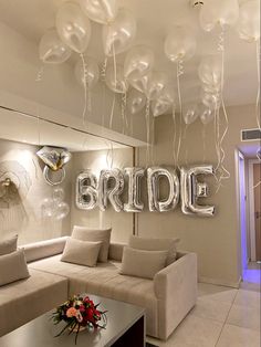 a living room filled with furniture and balloons