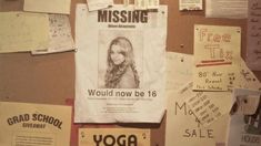 a bulletin board is covered with papers and posters, including a young woman's face