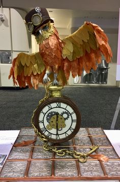 a clock with an eagle on it sitting on top of a table in front of a window