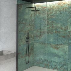 a bathroom with a glass shower door and tiled walls, including a black faucet